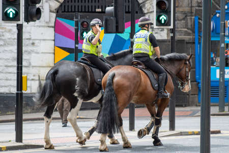 Leeds UK, 18th July 2019: Police officers riding a police horse in the Leeds Town Centre West Yorkshire.のeditorial素材