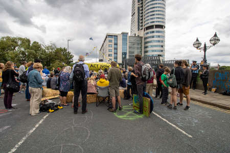 Leeds UK, 18th July 2019: The Extinction Rebellion Protest located in the Leeds City Centre on Victoria Bridge showing people holding signs about the protest.のeditorial素材