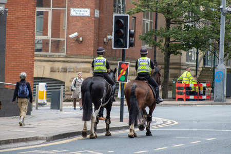 Leeds UK, 18th July 2019: Police officers riding a police horse in the Leeds Town Centre West Yorkshire.のeditorial素材