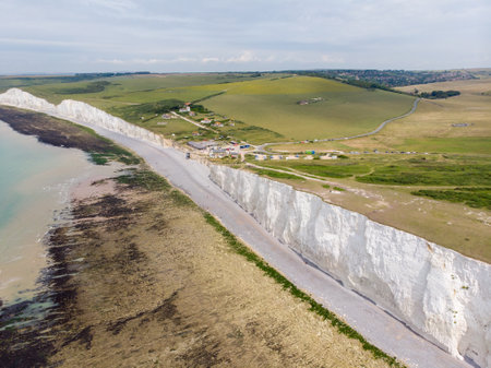 The famous Seven Sisters chalk cliffs by the English Channel. They form part of the South Downs in East Sussex, between the towns of Seaford and Eastbourne in southern England, taken on a bright day.の写真素材