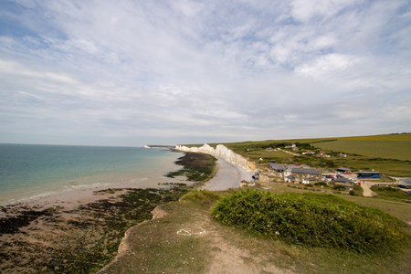 The famous Seven Sisters chalk cliffs by the English Channel. They form part of the South Downs in East Sussex, between the towns of Seaford and Eastbourne in southern England, taken on a bright day.の写真素材