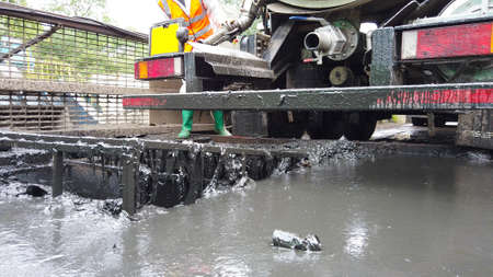 Photo of the back of a truck depositing sewage at a sewage water treatment plant located in the...