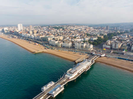 Aerial photo of the famous Brighton Pier and ocean located in the south coast of England UK that is part of the City of Brighton and Hove, taken on a bright sunny day showing the fairground rides.のeditorial素材