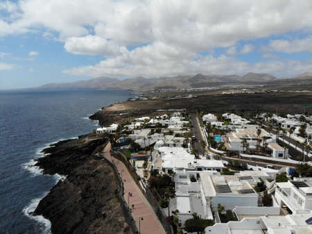 Aerial photo of the beautiful Lanzarote in Spain one of the Canary Islands, showing hotels and homes with the coastal area in the background.のeditorial素材