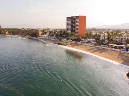Aerial photos of the beautiful beach and town of Puerto Vallarta in Mexico, the town is on the Pacific coast in the state known as Jalisco with the mountains in the background on a cloudy day.のeditorial素材
