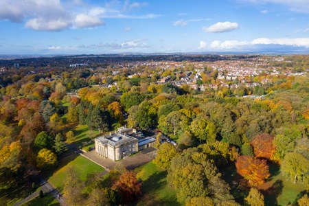 A beautiful aerial photo in the autumn fall at the park in Leeds West Yorkshire known as Roundhay Park showing the brown and green colours on the treesのeditorial素材
