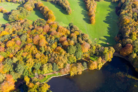 A beautiful aerial photo in the autumn fall at the park in Leeds West Yorkshire known as Roundhay Park showing the brown and green colours on the treesのeditorial素材