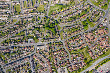 Top down aerial photo of the British town of Middleton in Leeds West Yorkshire showing typical suburban housing estates with rows of houses, taken on a bright sunny day using a drone.のeditorial素材