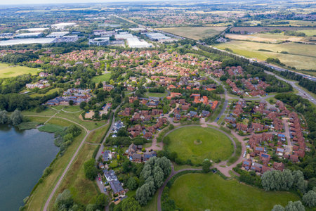 Aerial photo of the village of Milton Keynes in the UK showing a typical British housing estate on a sunny summers day taken with a drone from aboveのeditorial素材