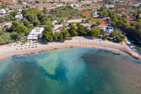 Aerial drone photo of the beautiful island of Ibiza in Spain showing the costal front golden sandy beaches with people relaxing and sunbathing on a hot sunny summers dayのeditorial素材
