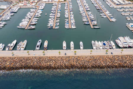 Aerial drone photo of the beautiful island of Ibiza in Spain showing the boating harbour with rows of speed and sail boats in the harbour on a bright sunny summers dayのeditorial素材