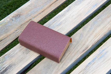 A sanding block on a wooden bench ready to sand down, home improvement woodworking conceptの写真素材