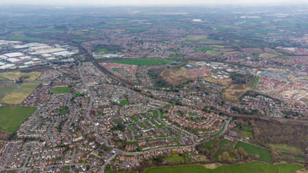 Aerial drone photo of a typical residential housing estate in England showing a very high view of the village of Wakefield in West Yorkshire in the UK taken in the spring timeの写真素材