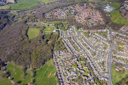 Aerial photo of the British town of Meanwood in Leeds West Yorkshire showing typical UK housing estates and rows of houses from above in the spring time on a sunny dayの写真素材