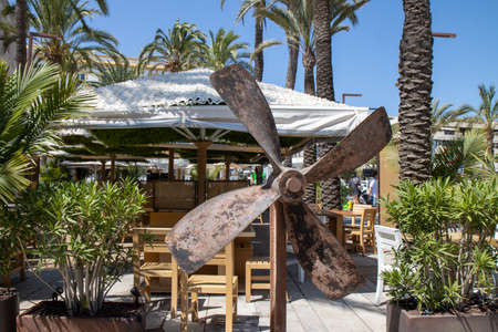 An old rusty boats rudder outside a bar in the town of Ibiza in Spainの写真素材
