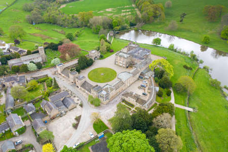 Aerial photo of the small village of Ripley in Harrogate, North Yorkshire in the UK showing the historical British Ripley Castle Wedding Venue along side the Ripley Lakeのeditorial素材