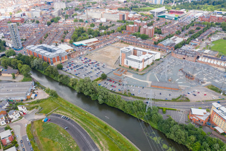 Aerial photo of the city centre of Leicester in the UK showing houses and apartment building on a sunny summers day along side the river and power stationのeditorial素材
