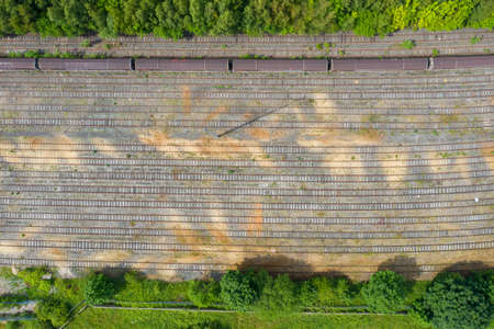 Top down aerial photo of old abandoned railway tracks with an old train on the tracks in the summer...