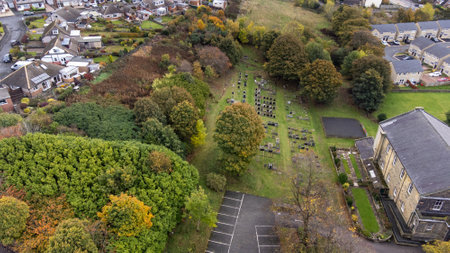 Aerial photo of the the town of Woodthorpe, it's a suburb in the south west of the city of York, North Yorkshire, England showing an aerial view of a grave yard cemetery in the autumn timeの写真素材