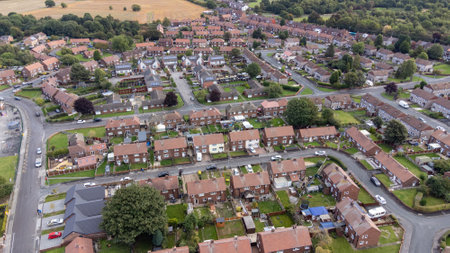 Aerial drone photo of the village of Sharlston and Sharlston Common in Wakefield in the UK, showing the residential housing estates of the village on a sunny day in the summer time.の写真素材