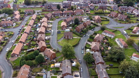 Aerial drone photo of the village of Sharlston and Sharlston Common in Wakefield in the UK, showing the residential housing estates of the village on a sunny day in the summer time.の写真素材