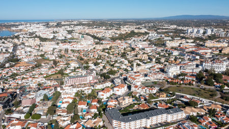 Aerial photo of the beautiful town in Albufeira in Portugal showing the pretty town on a hot summers day with blue skies on a hot summers day in the summer time.の写真素材