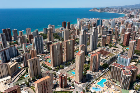 Aerial drone photo of the beautiful city of Benidorm in Spain in the summer time showing high rise apartments hotels and the main roads in the city in the summer timeの写真素材
