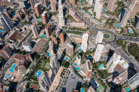 Aerial drone photo of the beautiful city of Benidorm in Spain in the summer time showing high rise apartments hotels and the main roads in the city in the summer timeの写真素材