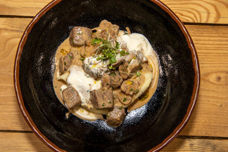 A delicious bowl of creamy Beef Stroganoff in a brown bowlの写真素材