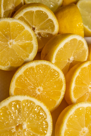 A pile of fresh cut lemons in a pileの写真素材