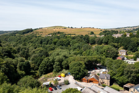 Aerial photo of a Yorkshire town in the UK, showing residential housing estates with trees and farmers fields in the background on a sunny summer dayの写真素材