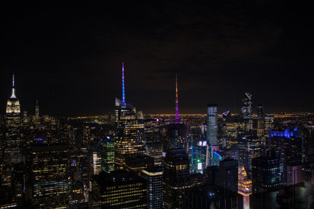 Night time aerial view of Manhattan in New York City showing the classic high rise buildings and...