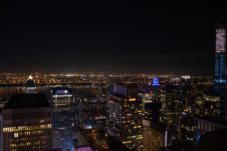 Night time aerial view of Manhattan in New York City showing the classic high rise buildings and city scape in the USA and the Empire State Building.の写真素材