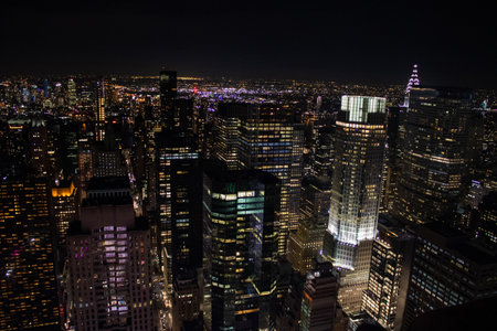 Night time aerial view of Manhattan in New York City showing the classic high rise buildings and...