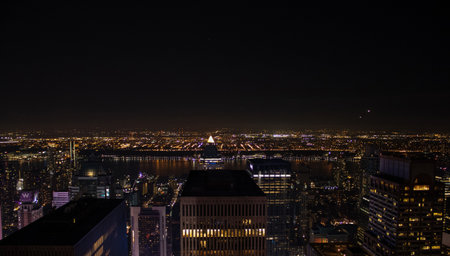 Night time aerial view of Manhattan in New York City showing the classic high rise buildings and city scape in the USA and the Empire State Building.の写真素材
