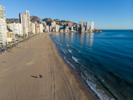 Aerial photo taken in Benidorm in Spain Alicante, showing the beautiful beach of Playa Levante, hotels, buildings, and high rise skyline cityscape with people relaxing on the beautiful beachの写真素材