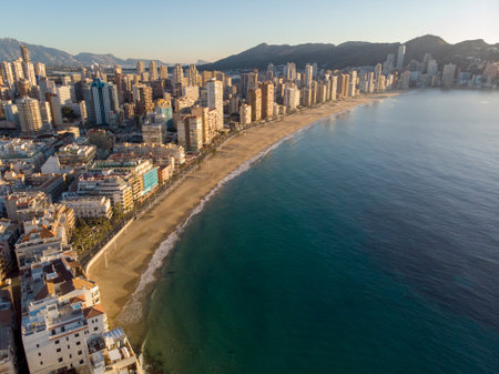 Aerial photo taken in Benidorm in Spain Alicante, showing the beautiful beach of Playa Levante, hotels, buildings, and high rise skyline cityscape with people relaxing on the beautiful beachの写真素材