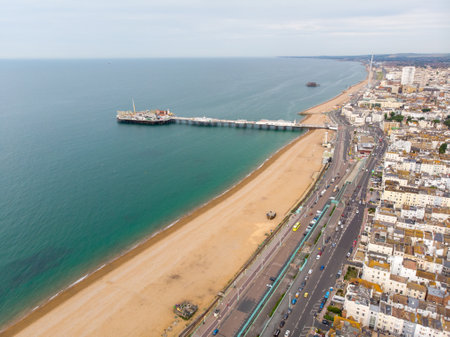 Aerial photo of the famous Brighton Pier and ocean located in the south coast of England UK that is part of the City of Brighton and Hove, taken on a bright sunny day showing the fairground rides.の写真素材
