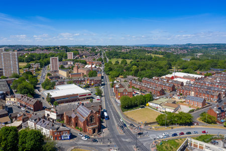 Aerial photo of the town centre of Armley in Leeds West Yorkshire on a bright sunny summers day showing apartment blocks flats and main roads going in to the townの写真素材