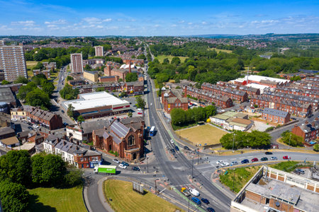 Aerial photo of the town centre of Armley in Leeds West Yorkshire on a bright sunny summers day showing apartment blocks flats and main roads going in to the townの写真素材