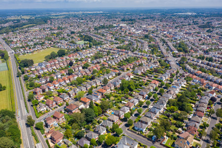 Aerial drone photo of a typical British housing estate located in the town of Bournemouth in the summer time showing rows of suburban houses, gardens and streetsの写真素材