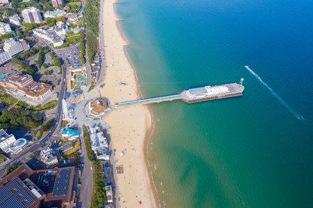 Aerial drone photo of the Bournemouth beach, Observation Wheel and Pier on a beautiful sunny summers day with lots of people relaxing and sunbathing on the British Dorset sandy beach and oceanの写真素材