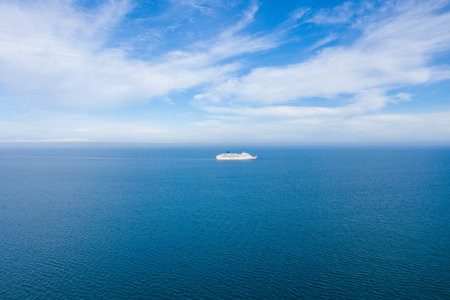 Aerial photo of a large ocean liner cruise ship in the ocean on a bright sunny summers day in on the coast near Bournemouth in the UKの写真素材