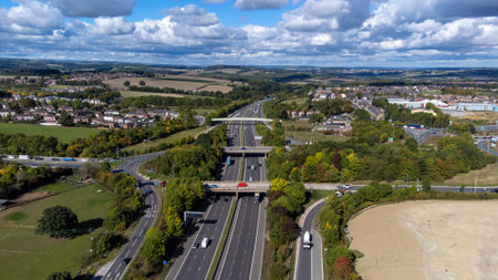 Aerial drone photo of the busy M1 motorway with three bridges crossing over the highway in Sheffield UK in the summer time on a bright sunny summers day.の写真素材