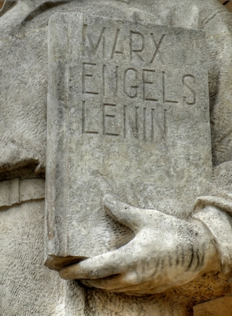 Closeup of a statue outside the palace of culture in warsaw with a cover book where Stalin name was removedの写真素材
