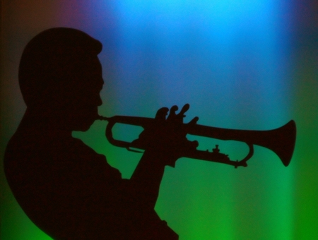 Saxophonist silhouette in a jazz barの写真素材