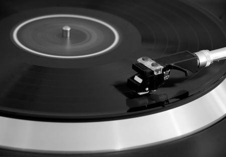 Vintage turntable player with vinyl spinning