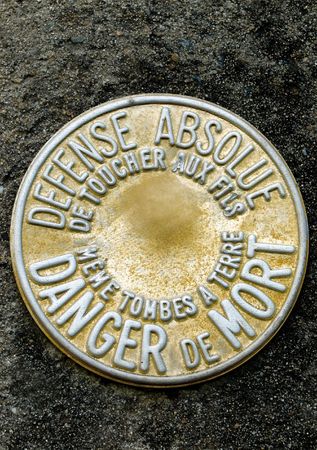 Closeup of an electrical pole warning sign in Frenchの写真素材