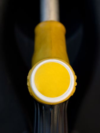 Yellow gas pump closeup with black backgroundの写真素材