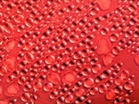 Macro of droplets on pink surface